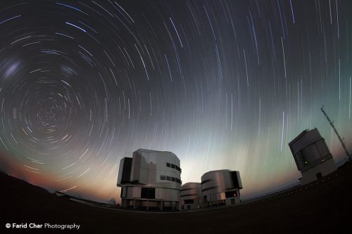 The close of day leaves a band of pale light on the horizon as the stars swing about overhead at Paranal.